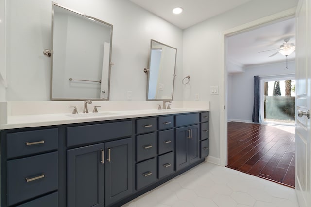 bathroom featuring double vanity, ceiling fan, and a sink