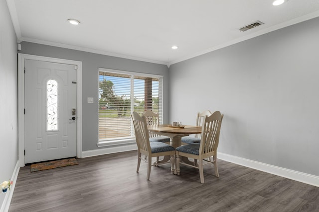 dining room featuring dark hardwood / wood-style floors and crown molding