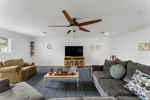 living room featuring ceiling fan, dark hardwood / wood-style floors, a textured ceiling, and ornamental molding