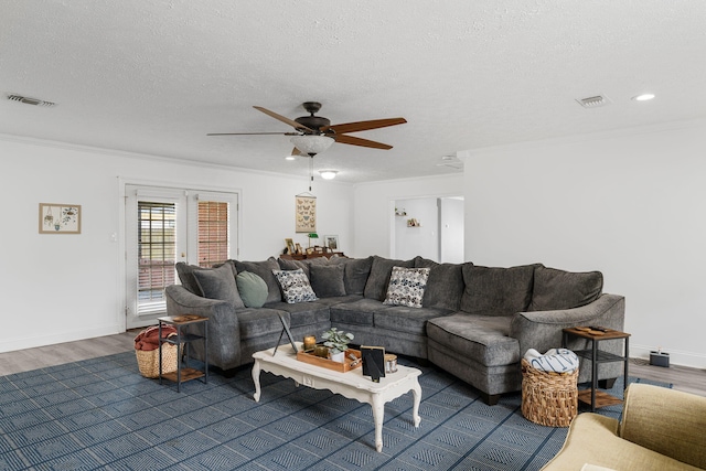 living room with a textured ceiling, ceiling fan, crown molding, and dark hardwood / wood-style floors