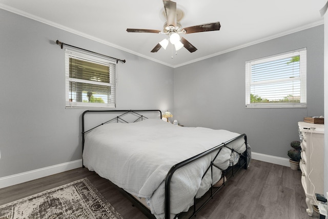 bedroom featuring ceiling fan, crown molding, and dark wood-type flooring