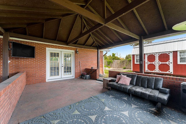 view of patio / terrace featuring french doors and a storage shed