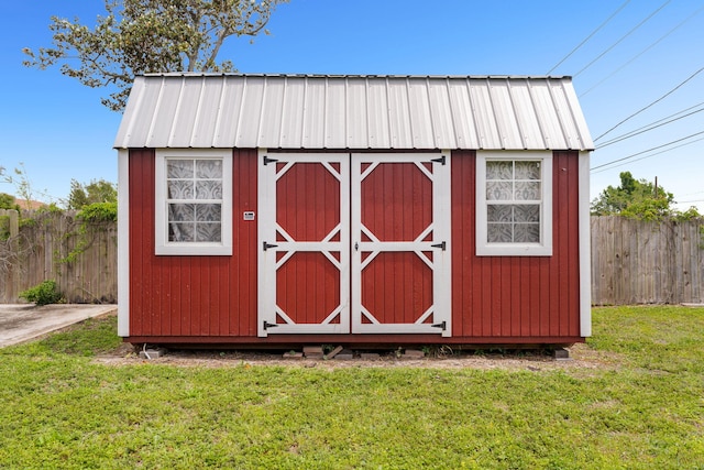 view of outbuilding featuring a lawn