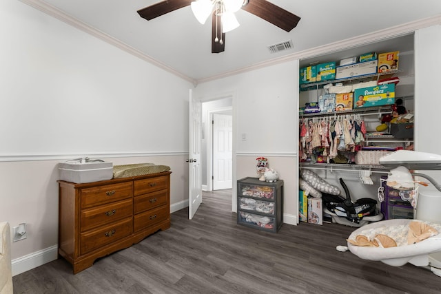 misc room with ceiling fan, dark hardwood / wood-style flooring, and ornamental molding