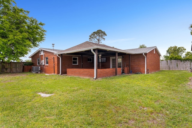 back of house featuring a yard and cooling unit