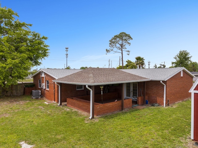 rear view of house with a yard