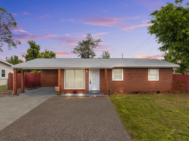 single story home featuring a yard and a carport