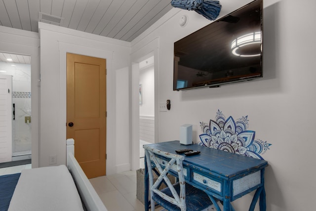 interior space featuring light tile patterned floors, wooden ceiling, and visible vents