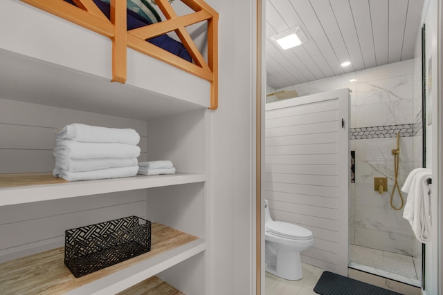 full bathroom featuring a marble finish shower and toilet