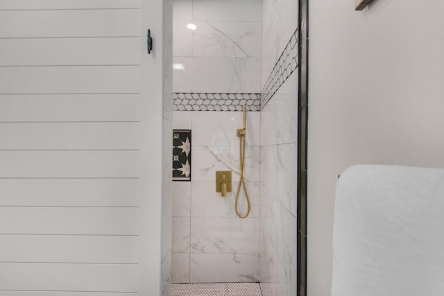 full bathroom with a marble finish shower