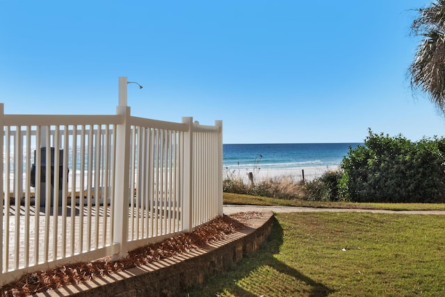 exterior space with a water view, a yard, and a beach view