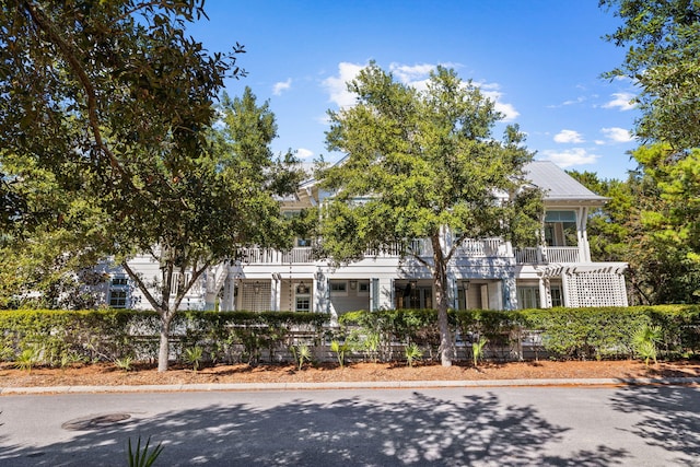 view of front of house featuring a balcony