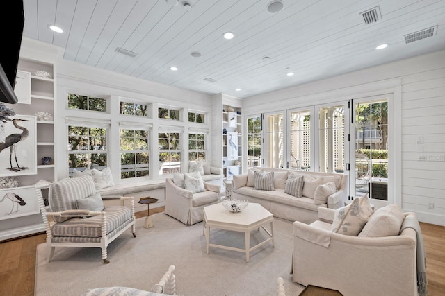 sunroom / solarium featuring wooden ceiling and a healthy amount of sunlight