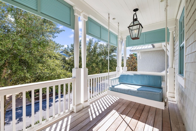 wooden terrace featuring covered porch