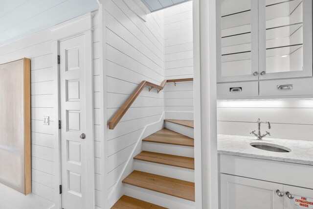 stairs with wooden walls and sink