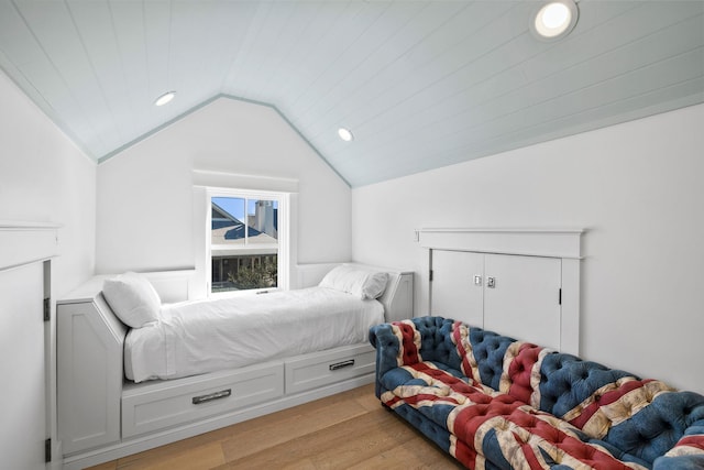 bedroom with lofted ceiling and light wood-type flooring