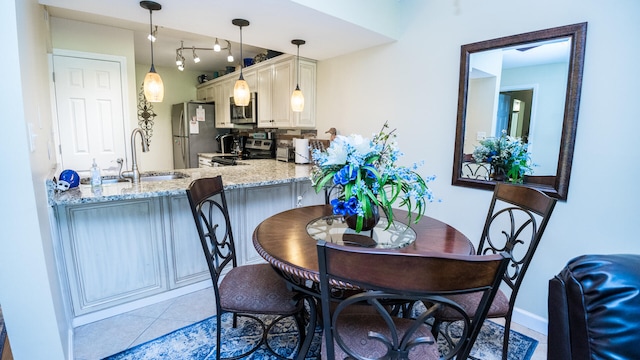 dining area featuring light tile patterned floors and sink