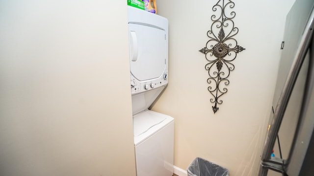 laundry area featuring stacked washing maching and dryer