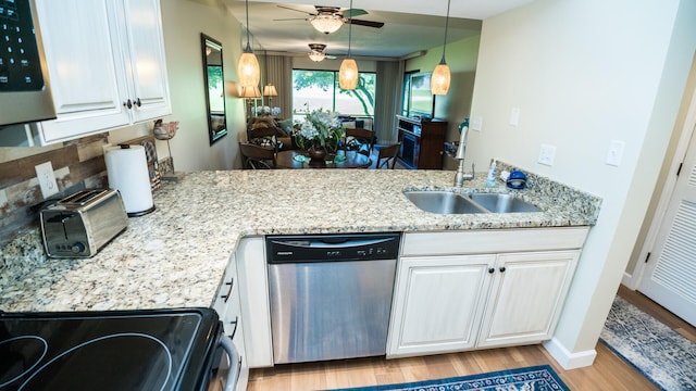 kitchen with light stone countertops, stainless steel dishwasher, light hardwood / wood-style flooring, black range, and white cabinetry