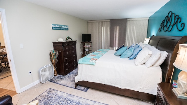 bedroom with light tile patterned floors