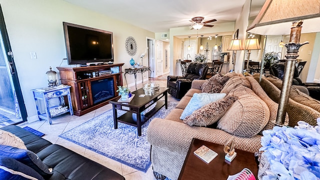 living room with a fireplace, ceiling fan, and light tile patterned flooring