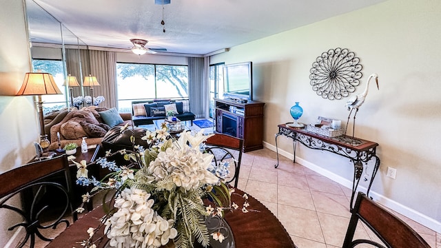 living room with ceiling fan and light tile patterned flooring