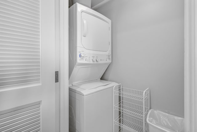 clothes washing area with stacked washer and clothes dryer