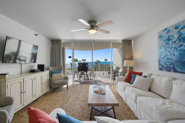 living room featuring floor to ceiling windows and ceiling fan