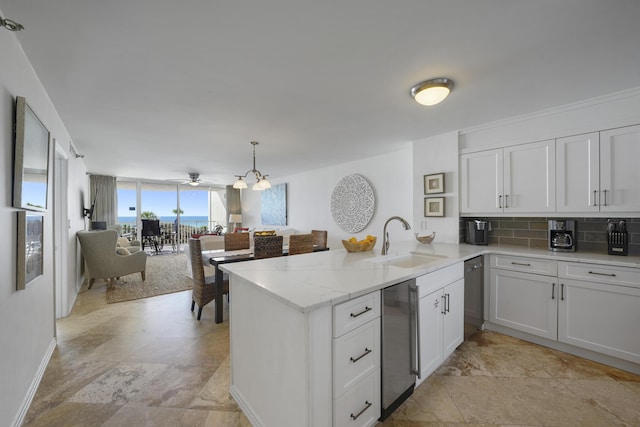 9815 US Highway 98 W Unit A202, Miramar Beach, FL 32550 - kitchen with a peninsula, decorative backsplash, dishwasher, white cabinets, and light stone countertops