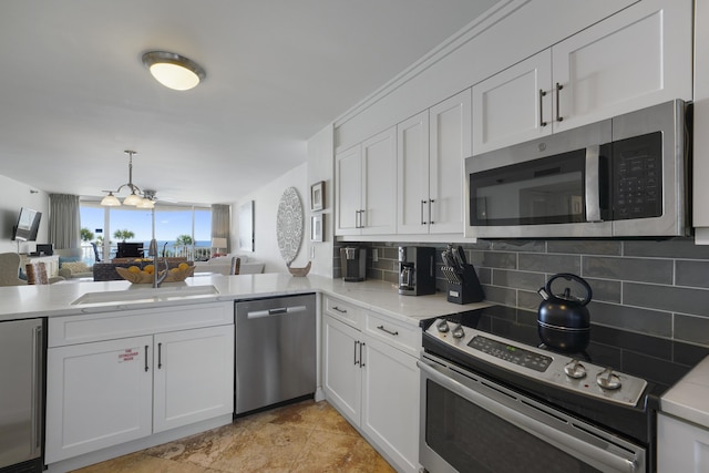 9815 US Highway 98 W Unit A202, Miramar Beach, FL 32550 - kitchen featuring appliances with stainless steel finishes, tasteful backsplash, white cabinets, and open floor plan