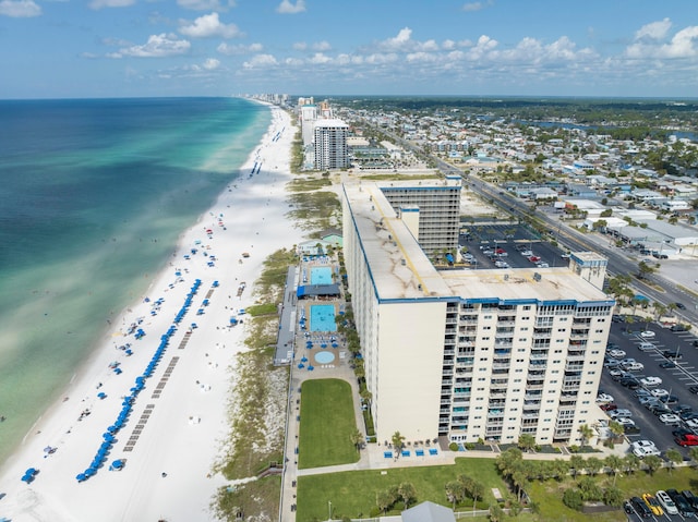 drone / aerial view featuring a beach view and a water view