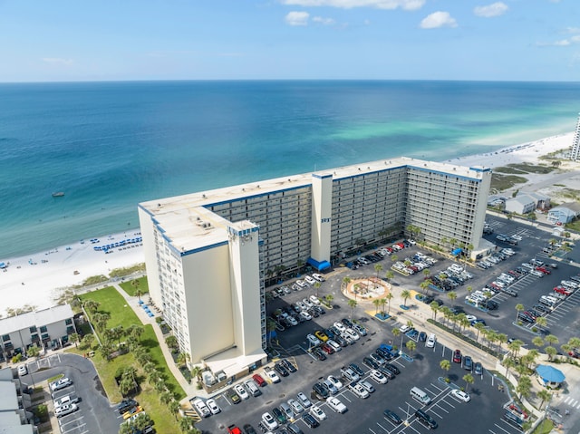 drone / aerial view featuring a beach view and a water view