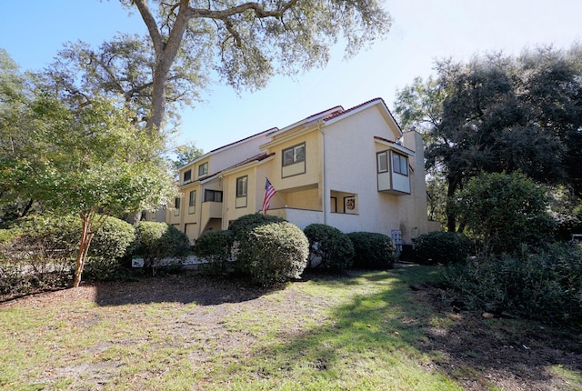 view of home's exterior with a yard