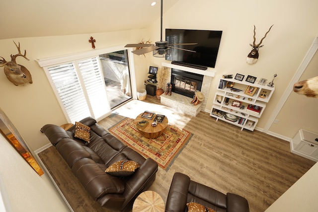 living room featuring hardwood / wood-style floors, vaulted ceiling, and ceiling fan