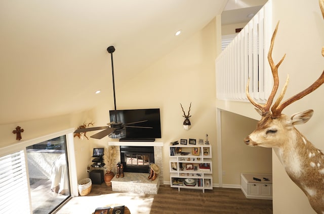 living room featuring ceiling fan, dark wood-type flooring, and high vaulted ceiling