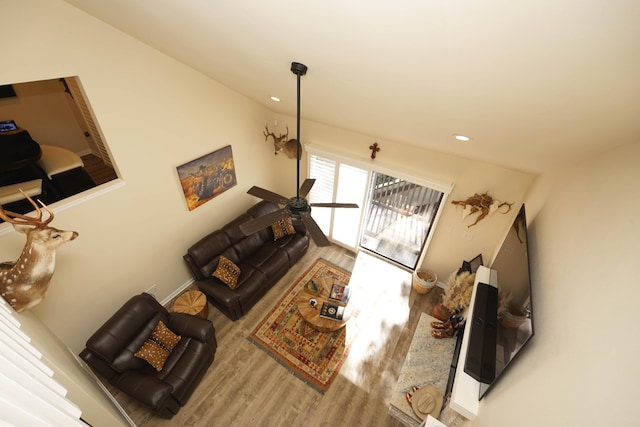 living room featuring ceiling fan and wood-type flooring