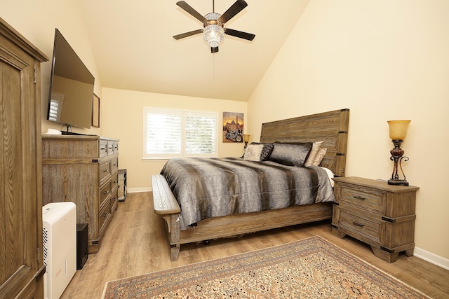 bedroom with ceiling fan, light hardwood / wood-style flooring, and high vaulted ceiling