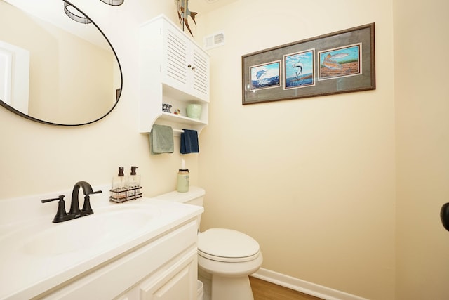 bathroom featuring hardwood / wood-style floors, vanity, and toilet