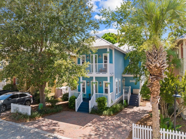 view of front of home with a porch and a balcony