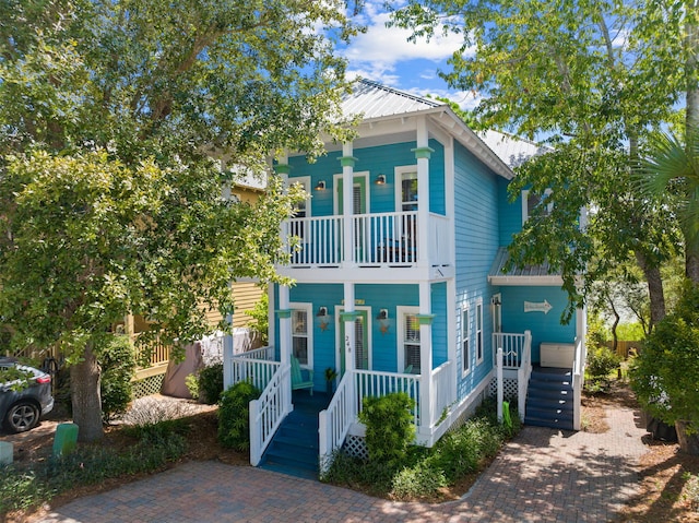 view of front of home featuring covered porch and a balcony