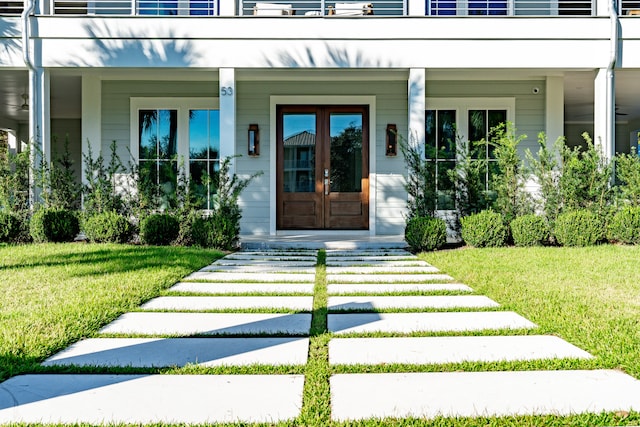 doorway to property with a yard and french doors