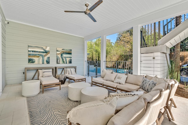 sunroom / solarium featuring ceiling fan and wood ceiling