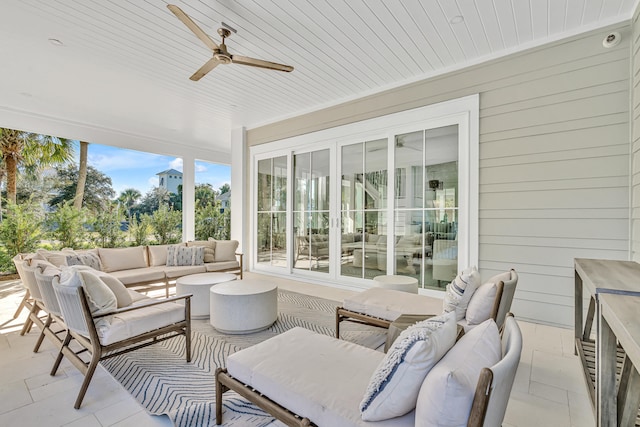 sunroom with ceiling fan and wooden ceiling