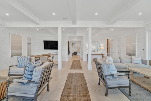 living room with wooden walls, crown molding, and beamed ceiling