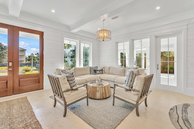 sunroom / solarium with a notable chandelier, beam ceiling, and french doors