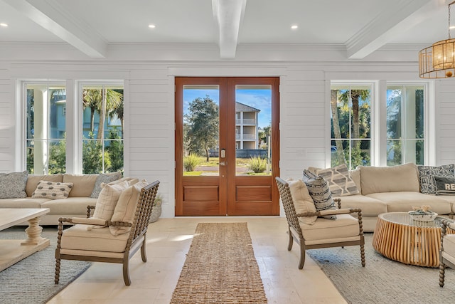 sunroom / solarium featuring beam ceiling and french doors