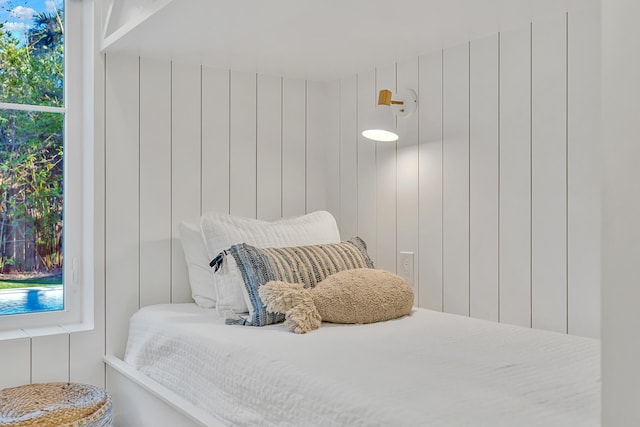 bedroom with wood walls