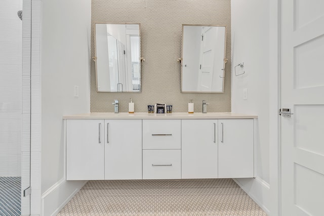 bathroom featuring tile patterned flooring, vanity, and a shower with shower door