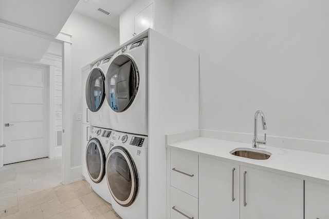 laundry room featuring sink, cabinets, stacked washer and dryer, and washing machine and dryer