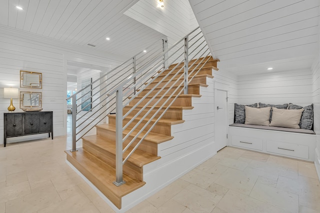 stairway with wooden walls and wood ceiling